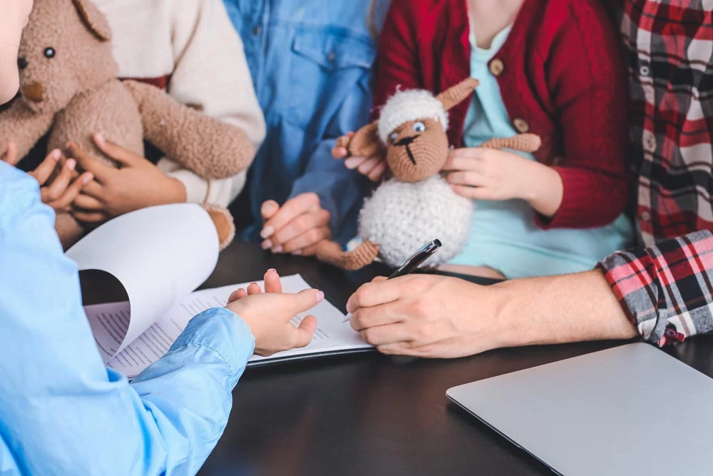 Social worker meeting with couple for signing adoption documents