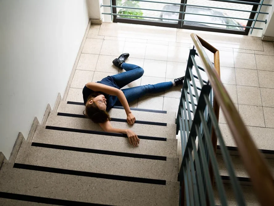 Slip And Fall Accident On Stairs. Worker Woman Fallen Down