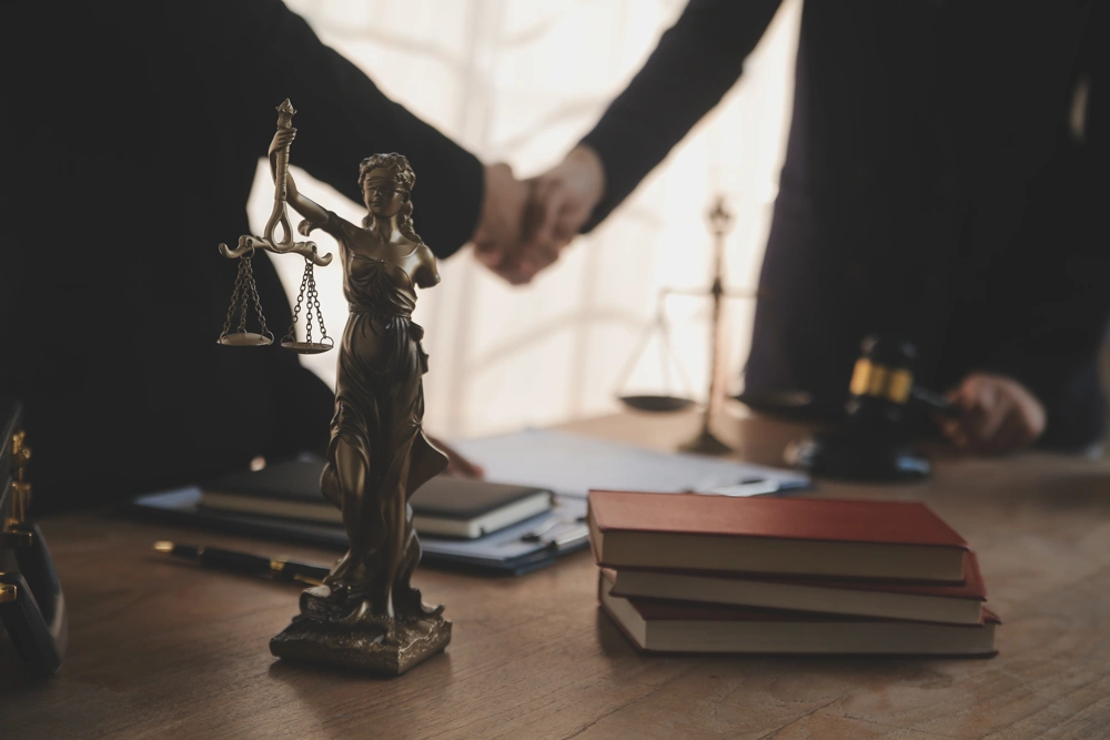 Lawyer shaking hands with a client making about documents, contracts, agreements
