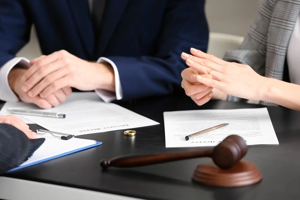 Young couple taking off wedding rings in lawyer's office