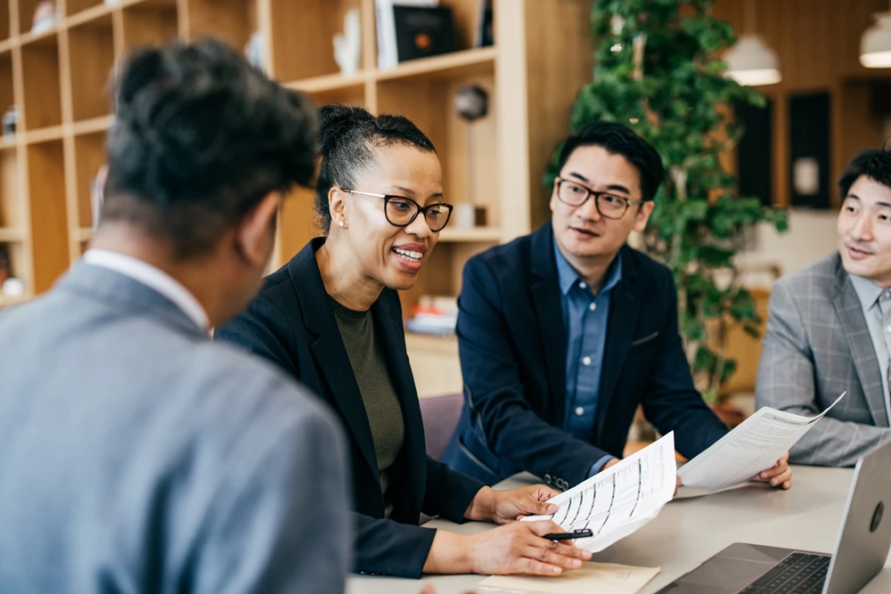 Three colleagues in discussion in the office