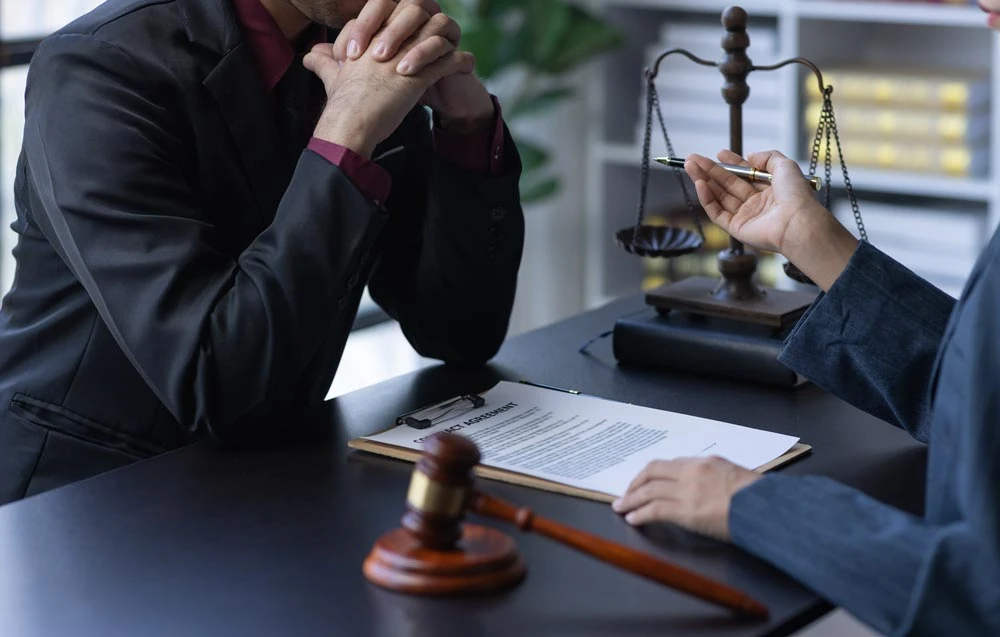 The boss is pointing in the face at the helper who misbehaved in business or legal matters in law firm office