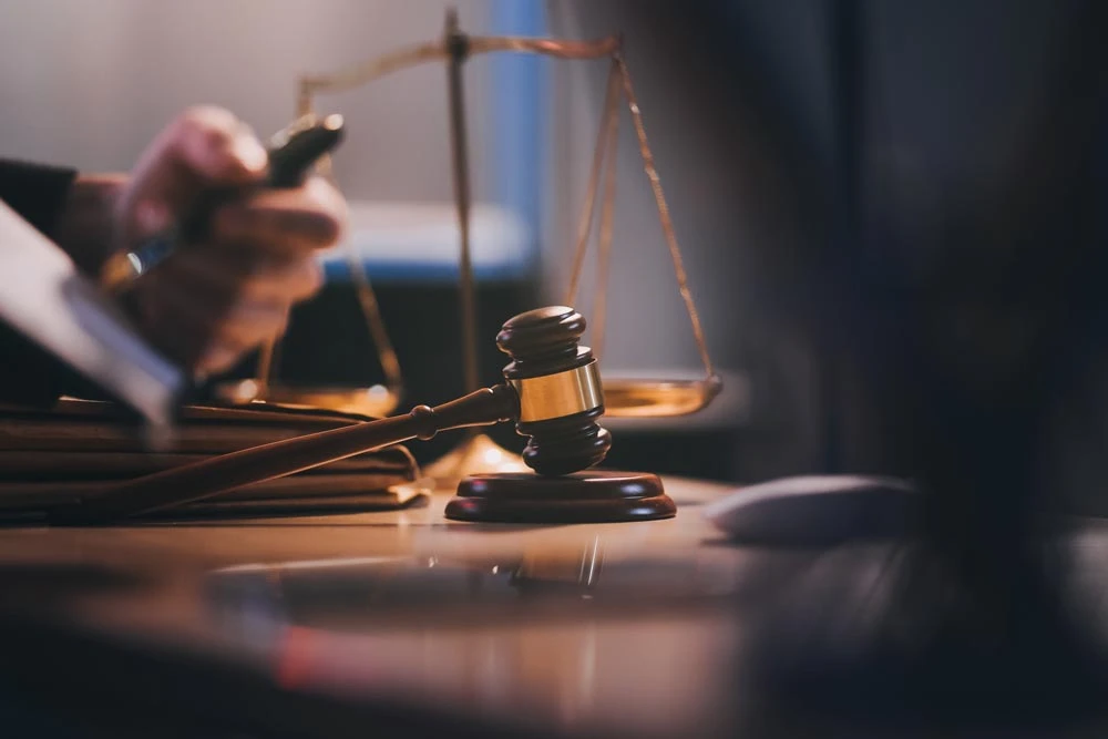 Judge gavel with Justice lawyers having team meeting at law firm background. Concepts of Law and Legal services.